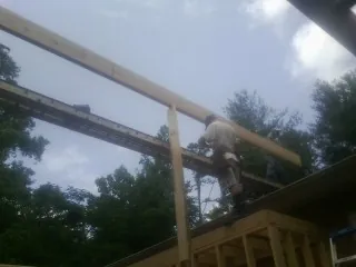 Carpenter setting a ridge beam over a new addition frame — Ice Dam Removal by Roofing Brothers in Bound Brook