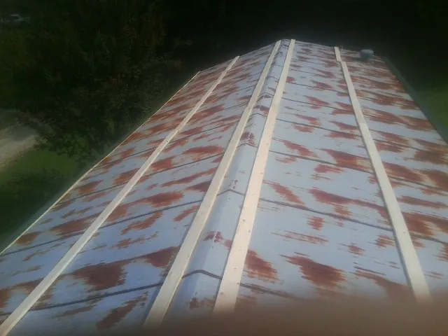 Rusted metal roof panels with new wood purlins before replacement — Storm Damage Roof Repair in Bound Brook by Roofing Brothers