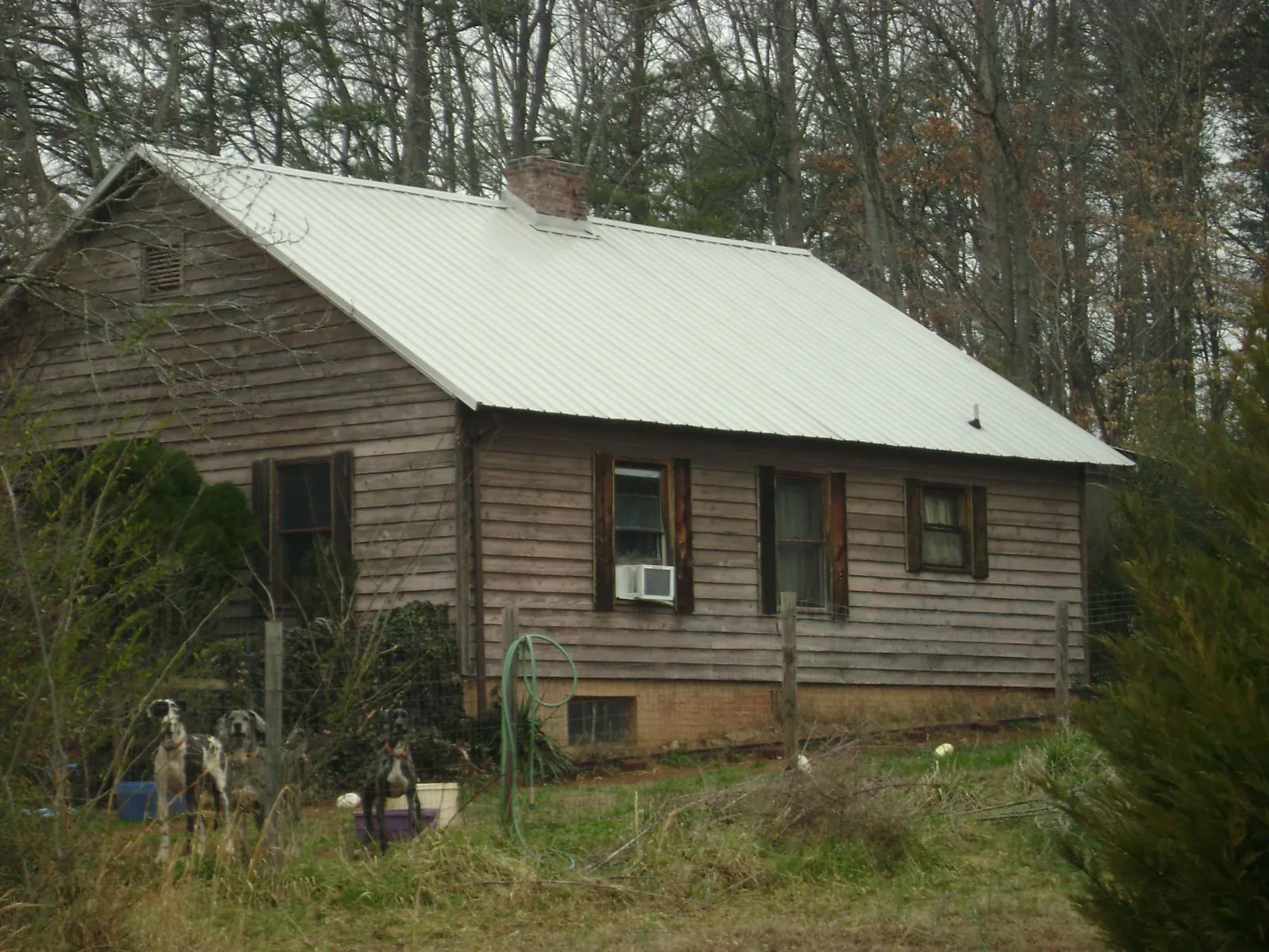 White metal roof on an old wood sided farmhouse, from a Asphalt Shingle Roof Repair job in Bound Brook